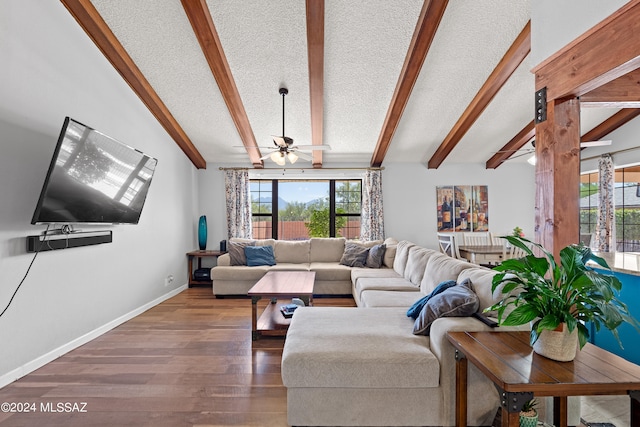 living room featuring a textured ceiling, lofted ceiling with beams, hardwood / wood-style floors, and ceiling fan