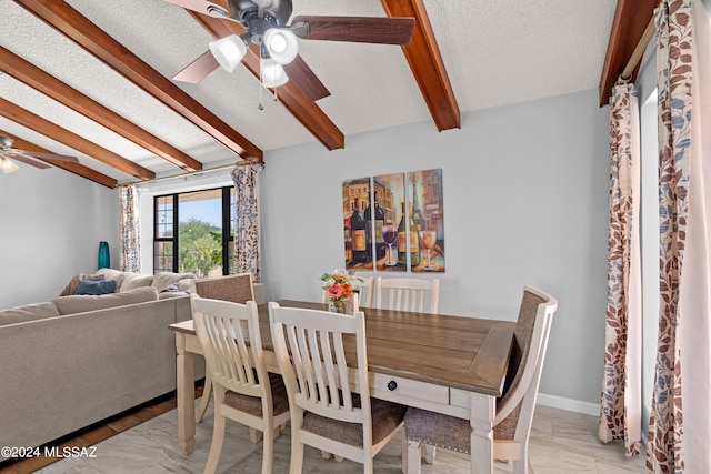 dining room with ceiling fan, vaulted ceiling with beams, and a textured ceiling