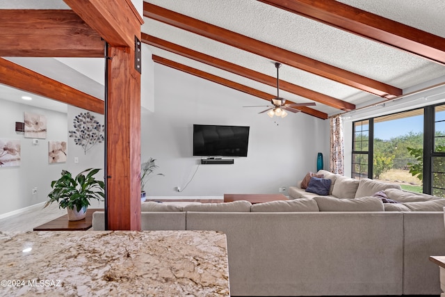 living room featuring ceiling fan and vaulted ceiling with beams