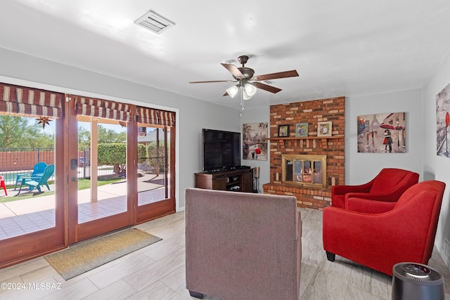 living room featuring french doors, visible vents, a fireplace, and ceiling fan