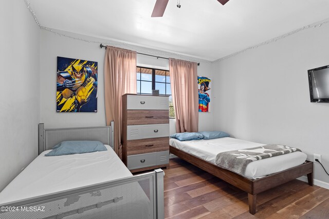 bedroom featuring ceiling fan and dark wood-type flooring