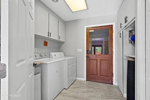 washroom with washer and dryer, baseboards, cabinet space, and marble finish floor