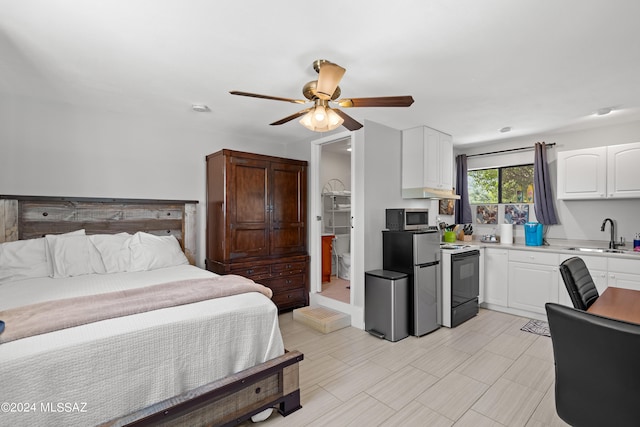 bedroom with stainless steel refrigerator, sink, and ceiling fan