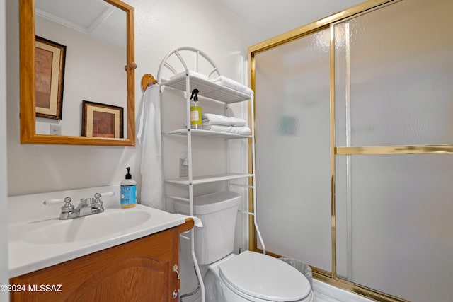 bathroom with an enclosed shower, vanity, and toilet