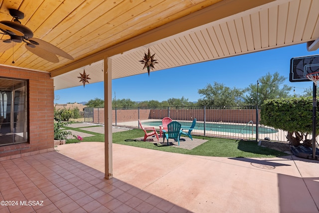 view of patio / terrace featuring ceiling fan and a fenced in pool