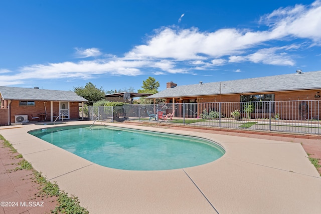 view of pool with a patio and ac unit