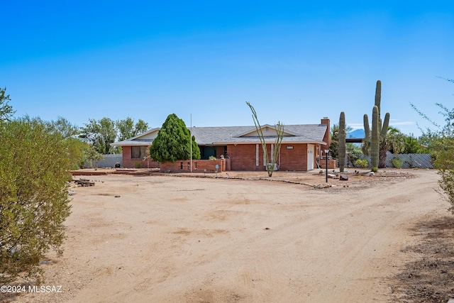 view of front of house featuring fence and a chimney