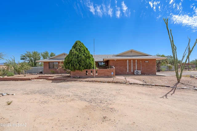 ranch-style house with fence