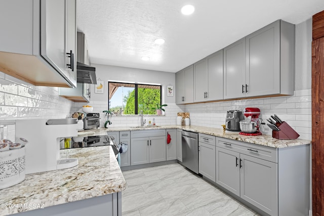 kitchen with gray cabinets, tasteful backsplash, sink, stainless steel appliances, and light stone countertops