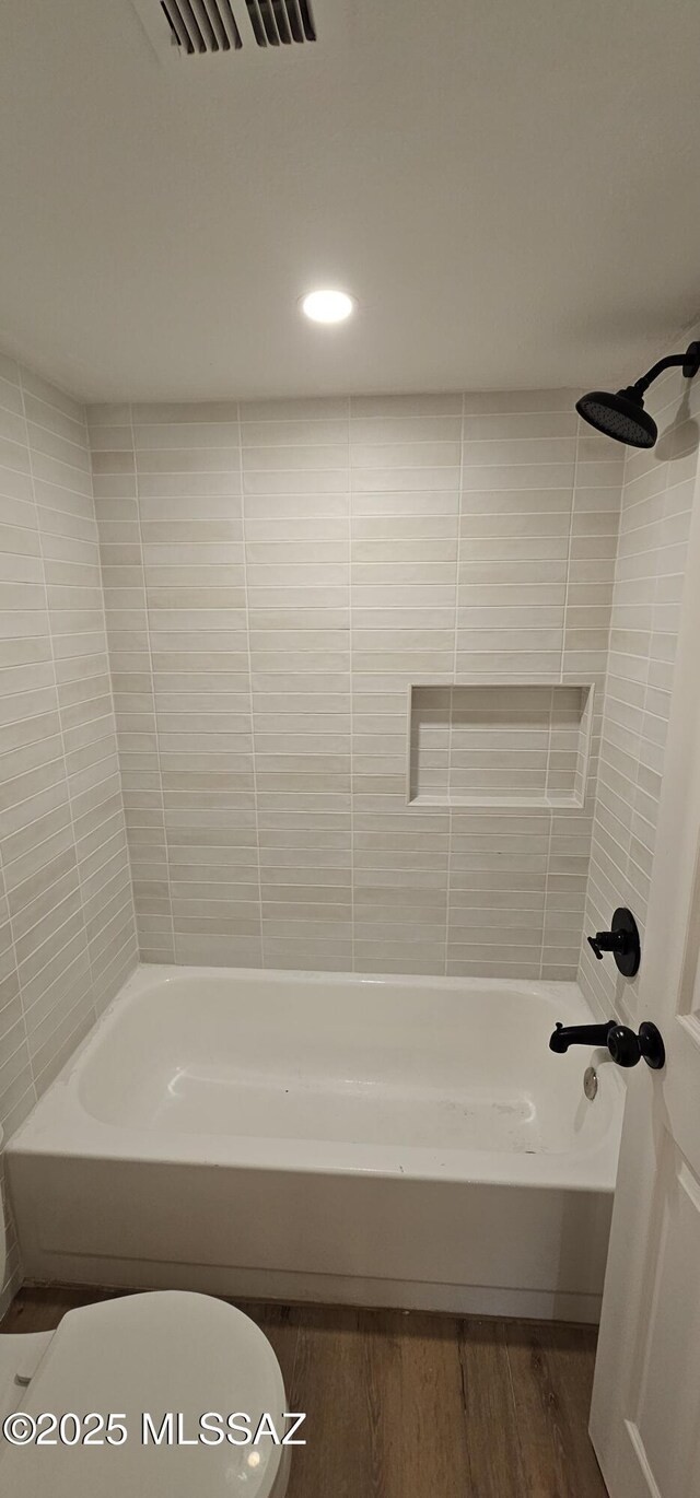 unfurnished bedroom featuring connected bathroom, ceiling fan, light colored carpet, and multiple windows