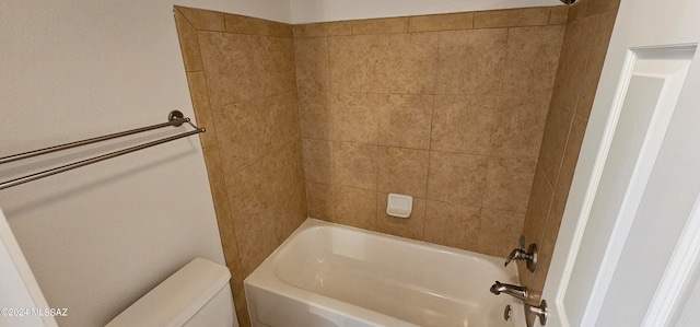 bathroom with tiled shower / bath combo and toilet