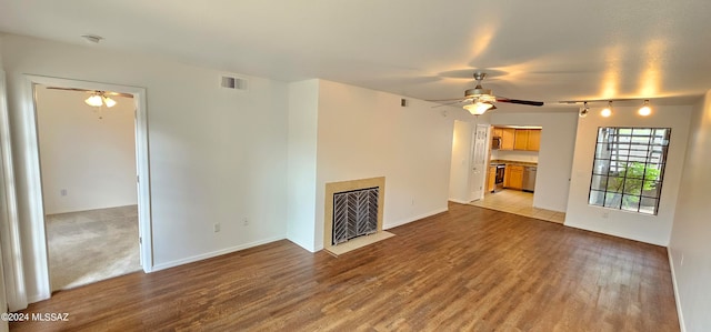 unfurnished living room with ceiling fan and light wood-type flooring