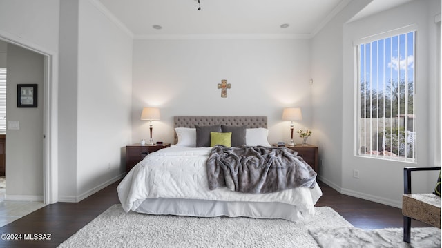 bedroom featuring dark hardwood / wood-style floors and ornamental molding