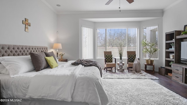 bedroom with crown molding, ceiling fan, and dark wood-type flooring