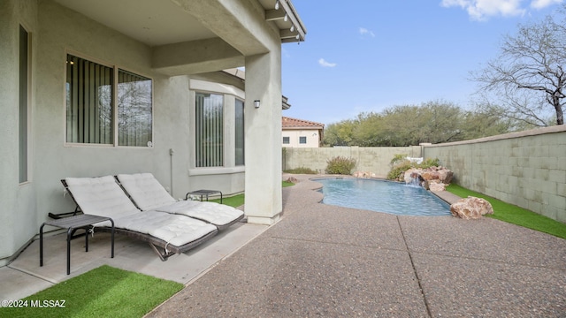 view of pool featuring pool water feature and a patio