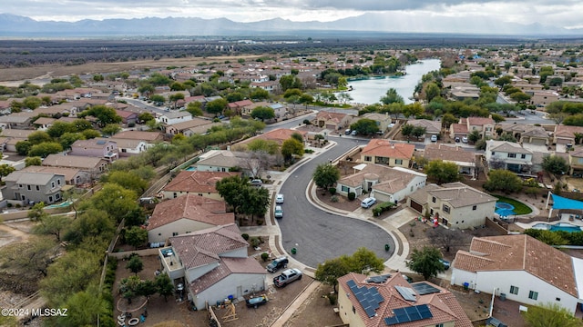 drone / aerial view with a water and mountain view