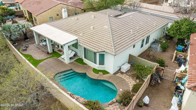 exterior space featuring a fenced in pool and a patio