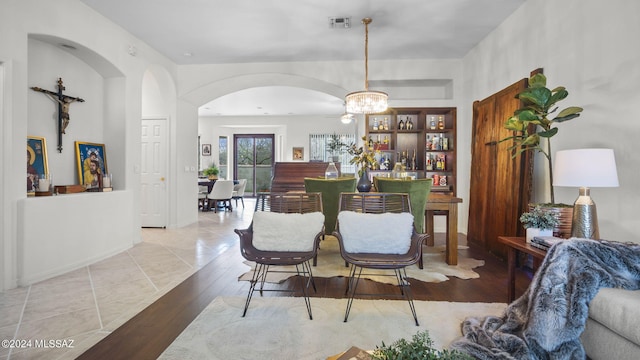 dining space featuring light hardwood / wood-style flooring and a chandelier