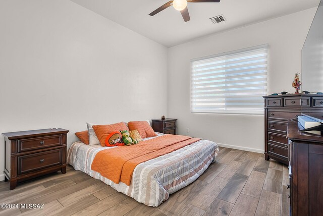 bedroom with hardwood / wood-style floors and ceiling fan