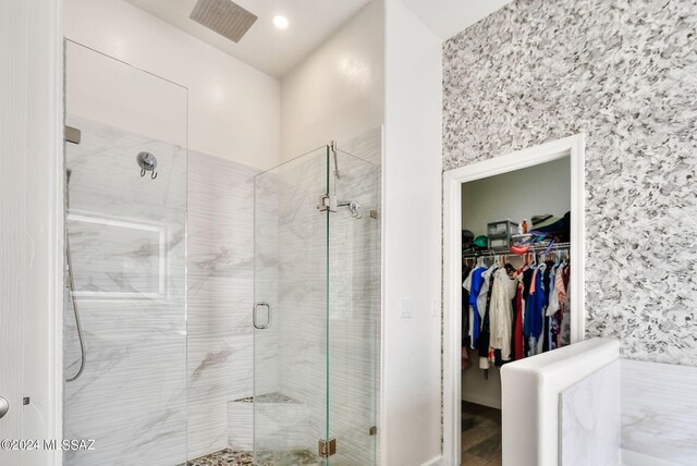 bathroom featuring hardwood / wood-style flooring and a shower with shower door