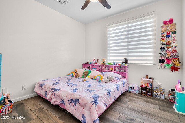 bedroom with ceiling fan and hardwood / wood-style flooring