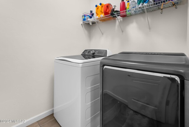 laundry area featuring washer and clothes dryer and tile patterned floors