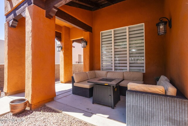 view of patio featuring an outdoor living space with a fire pit