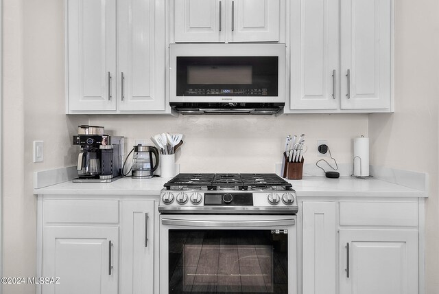 kitchen with appliances with stainless steel finishes and white cabinetry