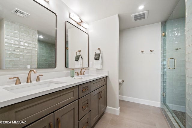 bathroom featuring vanity, tile patterned floors, and walk in shower