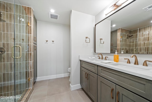 bathroom featuring walk in shower, tile patterned flooring, vanity, and toilet