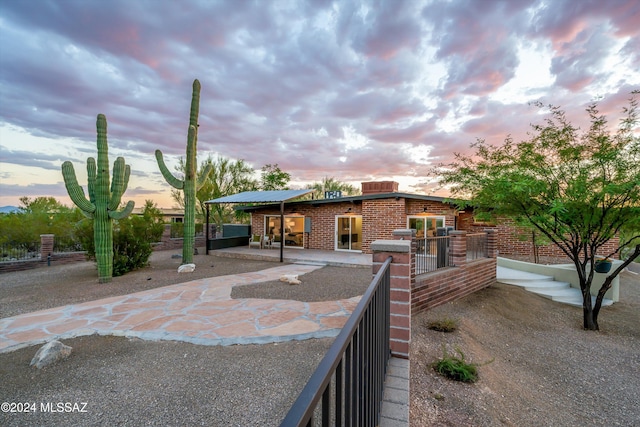 view of patio terrace at dusk