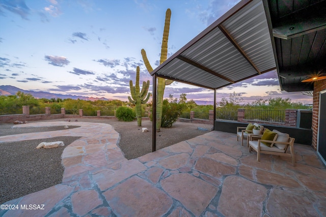 patio terrace at dusk featuring outdoor lounge area