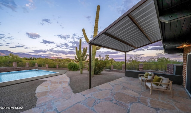 view of patio terrace at dusk