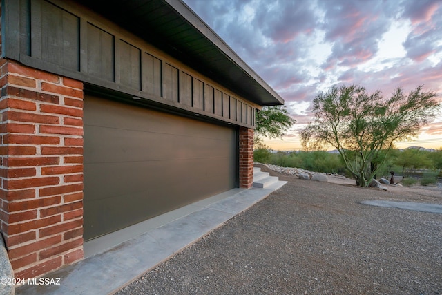 view of garage at dusk