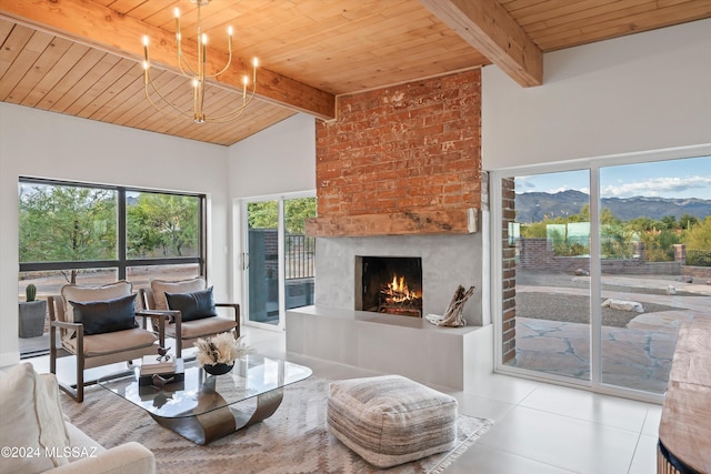 tiled living room with a large fireplace, wooden ceiling, an inviting chandelier, vaulted ceiling with beams, and a mountain view