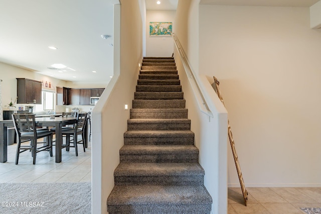 stairway with tile patterned floors