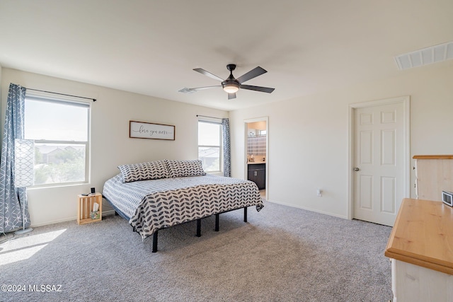 carpeted bedroom featuring ensuite bathroom and ceiling fan