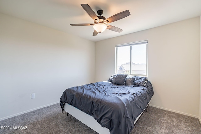 bedroom featuring dark colored carpet and ceiling fan