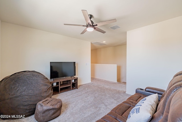 carpeted living room featuring ceiling fan