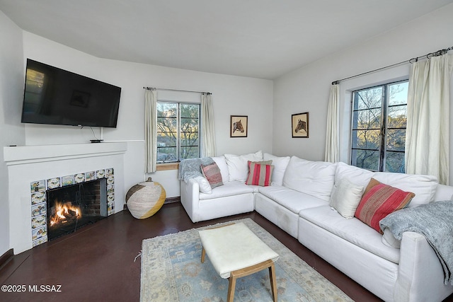 living room featuring plenty of natural light and a tiled fireplace