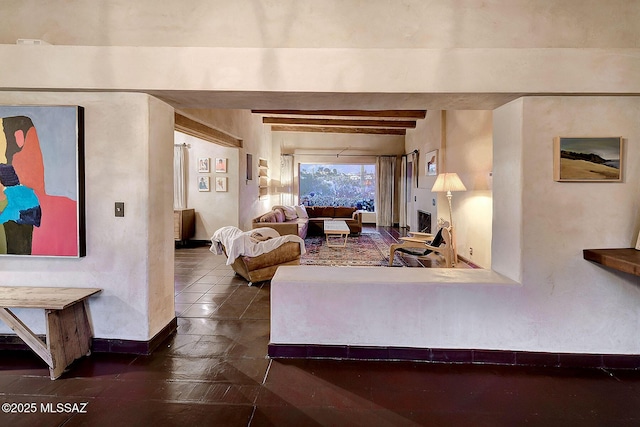 living room featuring beamed ceiling