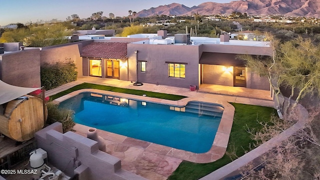 rear view of property featuring a mountain view and a patio area