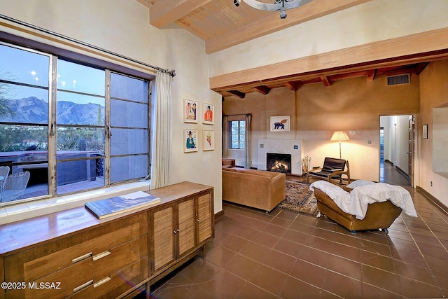 kitchen featuring a mountain view, high vaulted ceiling, dark tile patterned floors, beam ceiling, and wood ceiling