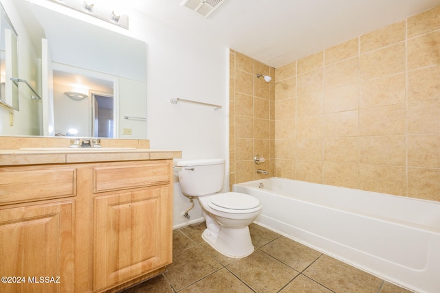 full bathroom featuring tile patterned flooring, vanity, toilet, and tiled shower / bath