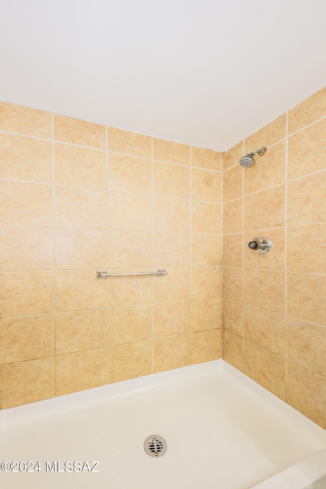 bathroom with a tile shower