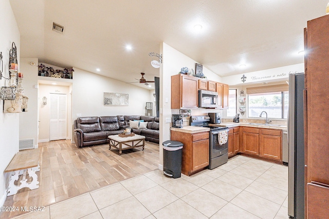 kitchen featuring ceiling fan, stainless steel appliances, sink, and lofted ceiling