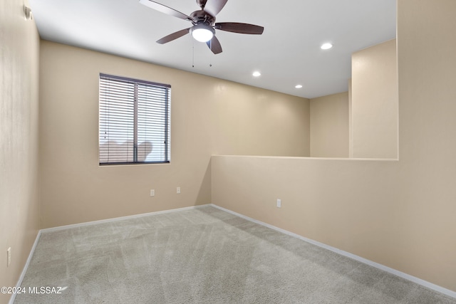 spare room with light carpet and ceiling fan