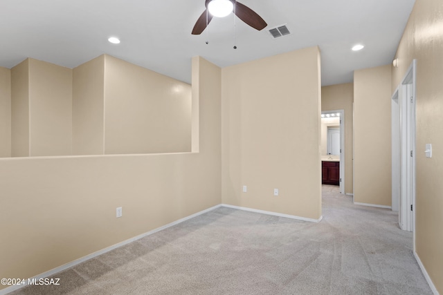 carpeted spare room with ceiling fan