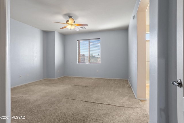 carpeted spare room featuring ceiling fan