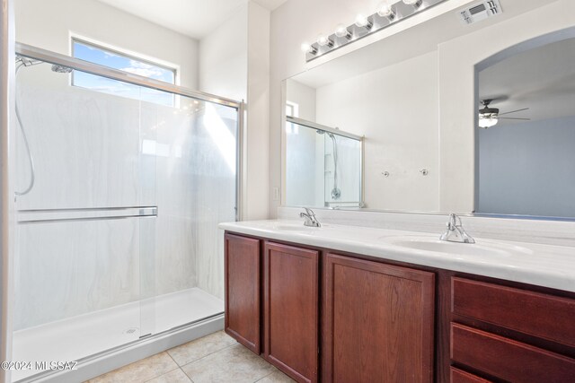 bathroom with walk in shower, vanity, tile patterned floors, and ceiling fan